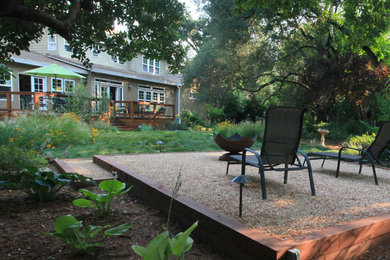 Diseño de jardín rural en patio trasero con exposición parcial al sol y gravilla