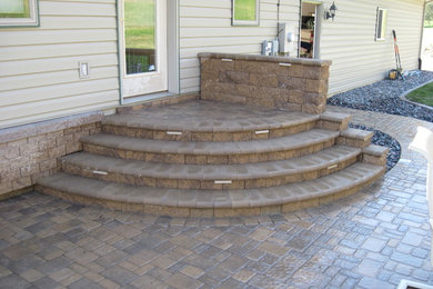Small elegant backyard brick patio photo in Other