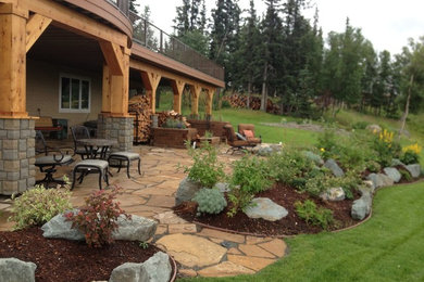 Patio - large craftsman backyard stone patio idea in Other with a fire pit and a roof extension