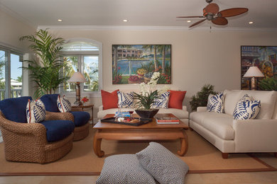Example of a mid-sized island style open concept limestone floor living room design in Miami with white walls, no fireplace and no tv