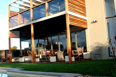 Inspiration for a mid-sized contemporary two-storey grey house exterior in Geelong with metal siding and a metal roof.