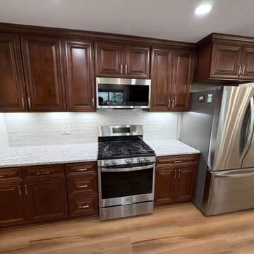 USCD cabinetry accompanied granite countertops, porcelain tile backsplash and Ca