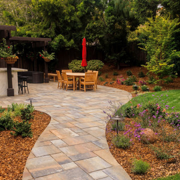 Backyard entertaining patio with dining and garden pathways