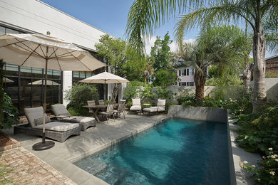 Small contemporary courtyard rectangular pool in Charleston with a water feature and brick pavers.