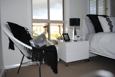 This is an example of a large modern master bedroom in Sydney with carpet.