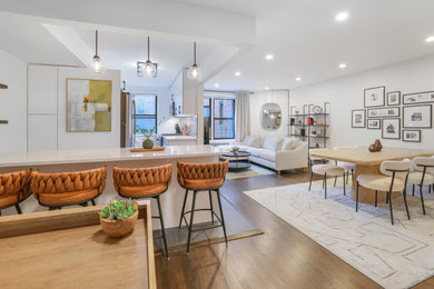 Example of a large transitional open concept dark wood floor and brown floor living room design in New York with white walls