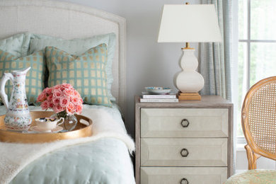 Large transitional guest medium tone wood floor and brown floor bedroom photo in Raleigh with beige walls