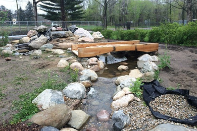 Inspiration for a large traditional full sun backyard gravel landscaping in Other.