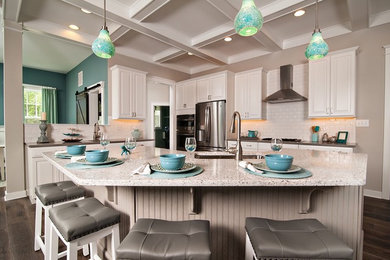 Kitchen - large coastal u-shaped medium tone wood floor and brown floor kitchen idea in Other with a single-bowl sink, raised-panel cabinets, white cabinets, granite countertops, white backsplash, subway tile backsplash, stainless steel appliances and an island