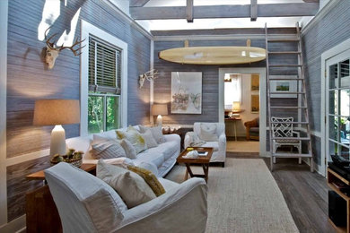 Mid-sized beach style open concept medium tone wood floor living room library photo in Jacksonville with gray walls, no fireplace and no tv