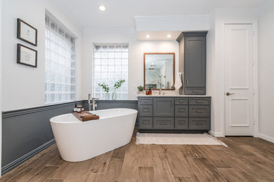 Inspiration for a large timeless master double-sink bathroom remodel in Dallas with gray cabinets, gray walls, granite countertops, a hinged shower door, gray countertops and a built-in vanity