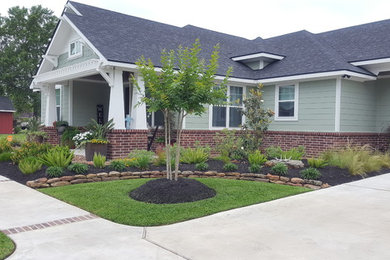Inspiration for a mid-sized craftsman green one-story mixed siding exterior home remodel in Houston with a shingle roof