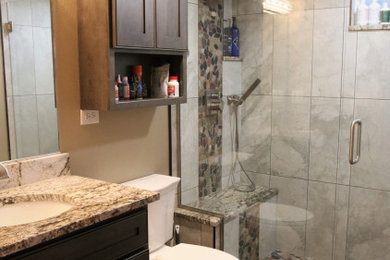 Example of a mid-sized minimalist master multicolored tile and porcelain tile porcelain tile, multicolored floor and single-sink bathroom design in Other with brown cabinets, an undermount sink, granite countertops, a hinged shower door, multicolored countertops and a freestanding vanity