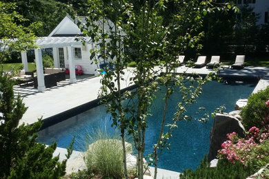Water slide - large traditional backyard stone and rectangular lap water slide idea in New York