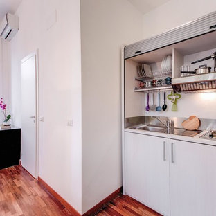 Small modern kitchen pantry ideas - Kitchen pantry - small modern medium tone wood floor and brown floor kitchen pantry idea in Rome with a double-bowl sink, gray cabinets and laminate countertops