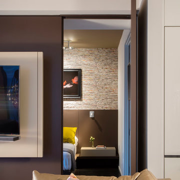 Invisible door provides access to bedroom beyond with custom bed