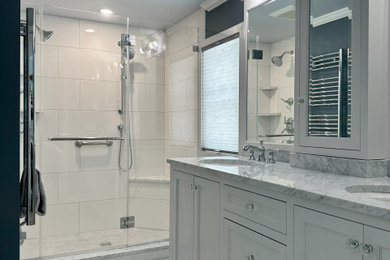 Inspiration for a master white tile and ceramic tile marble floor, white floor and double-sink bathroom remodel in Boston with recessed-panel cabinets, white cabinets, a one-piece toilet, gray walls, an undermount sink, marble countertops, a hinged shower door, white countertops and a built-in vanity