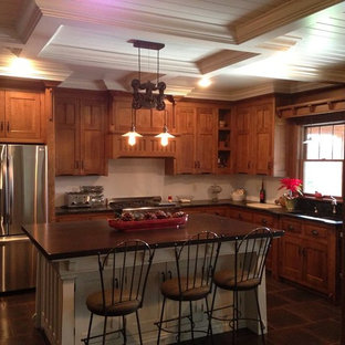 Mid-sized craftsman kitchen pantry ideas - Mid-sized arts and crafts l-shaped kitchen pantry photo in Columbus with a double-bowl sink, recessed-panel cabinets, medium tone wood cabinets, white backsplash, stainless steel appliances and an island