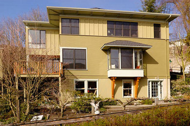 Inspiration for a large transitional green three-story wood exterior home remodel in Seattle