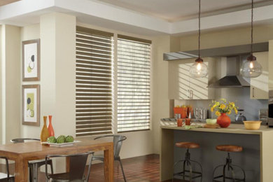 Mid-sized urban single-wall dark wood floor eat-in kitchen photo in Baltimore with an undermount sink, flat-panel cabinets, beige cabinets, quartz countertops, white backsplash, stainless steel appliances and an island