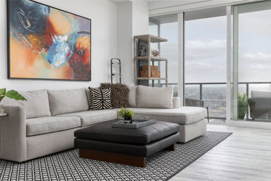 Example of a large trendy open concept vinyl floor and gray floor living room design in Newark with white walls and a wall-mounted tv