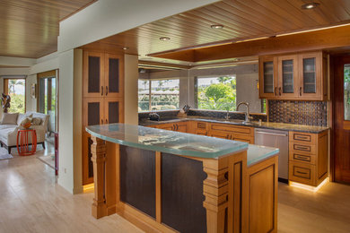 Inspiration for a large coastal l-shaped light wood floor and brown floor open concept kitchen remodel in Hawaii with a drop-in sink, glass-front cabinets, medium tone wood cabinets, glass countertops, brown backsplash, wood backsplash, stainless steel appliances, an island and turquoise countertops