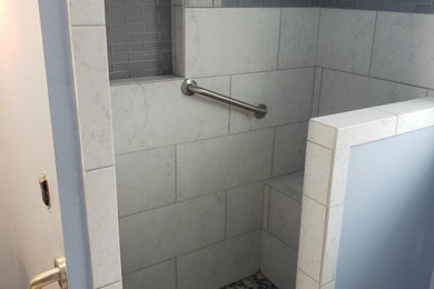 Example of a white tile bathroom design in Kansas City with blue walls