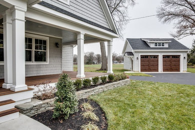 Example of a mid-sized arts and crafts white two-story wood exterior home design in Philadelphia with a shingle roof