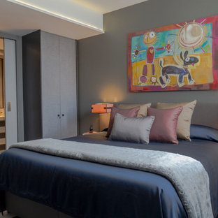 Design ideas for a medium sized modern bedroom in London with grey walls, no fireplace and grey floors.