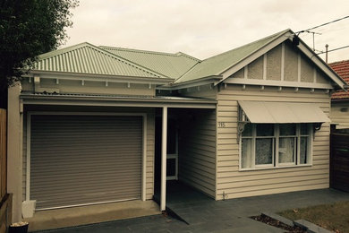 Small traditional one-storey beige exterior in Melbourne with wood siding.