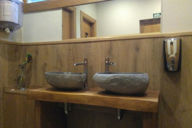 Photo of an asian bathroom in Bilbao with a vessel sink and wood benchtops.