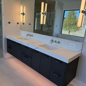 Primary Bathroom with Mitered Waterfall Tub Wall & Vanities