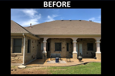 Large southwest backyard stone patio photo in Austin with a fireplace and a roof extension