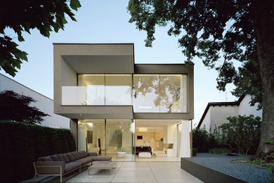 Inspiration for a mid-sized modern beige two-story glass exterior home remodel in Orlando