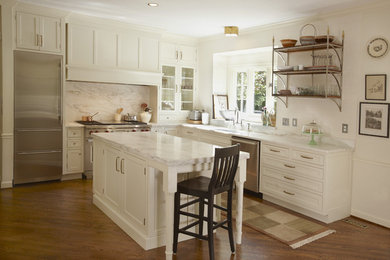 Large transitional l-shaped medium tone wood floor open concept kitchen photo in Chicago with a single-bowl sink, shaker cabinets, white cabinets, marble countertops, white backsplash, stone slab backsplash, stainless steel appliances and an island