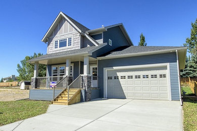 Mid-sized craftsman blue two-story vinyl gable roof idea in Toronto