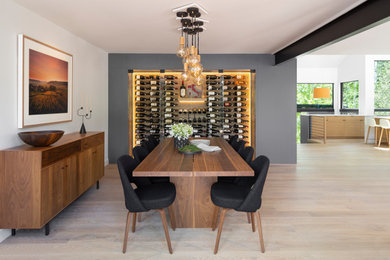 Design ideas for a mid-sized contemporary open plan dining in Denver with multi-coloured walls, light hardwood floors, beige floor and exposed beam.