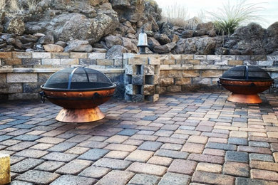 Photo of a large southwestern drought-tolerant and full sun backyard brick landscaping in Phoenix with a fire pit.