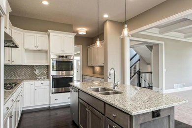 Example of a transitional brown floor kitchen design in Columbus with an island