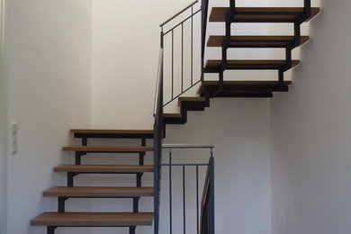 Mid-sized traditional painted wood straight staircase in Frankfurt with metal railing.
