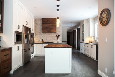 Design ideas for a country eat-in kitchen in Vancouver with shaker cabinets, white cabinets, wood benchtops, porcelain splashback, stainless steel appliances and with island.