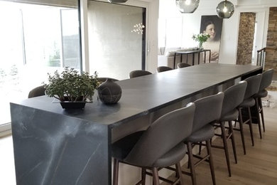 Example of a trendy kitchen design in Toronto with soapstone countertops, an island and black countertops