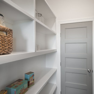 Mid-sized farmhouse kitchen pantry designs - Mid-sized cottage single-wall medium tone wood floor kitchen pantry photo in Wichita with an undermount sink, shaker cabinets, white cabinets, granite countertops, gray backsplash, subway tile backsplash, stainless steel appliances and an island