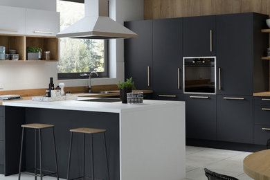 This is an example of a mid-sized modern u-shaped kitchen in Melbourne with black cabinets, stainless steel appliances, ceramic floors, with island, white floor and white benchtop.