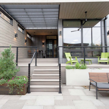 Modern Chicago Outdoor Retreat with Covered Terrace, Steel Railing, and Hardscap