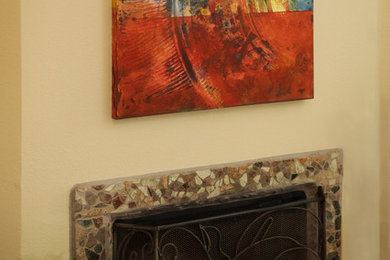 Example of a mid-sized trendy ceramic tile family room design in Phoenix with beige walls, a corner fireplace, a stone fireplace and no tv