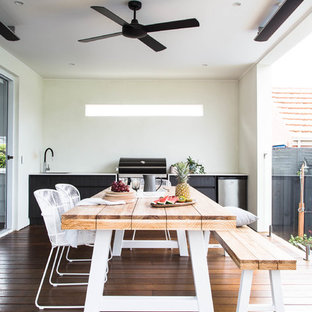 This is an example of a scandinavian backyard patio in Melbourne with decking and a pergola.
