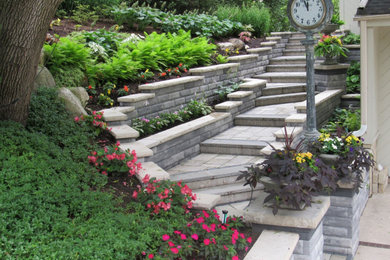 This is an example of a large modern front yard brick retaining wall landscape in Chicago.