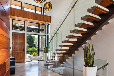 Large trendy entryway photo in Detroit with a medium wood front door and beige walls