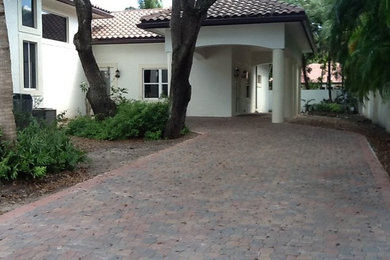 Large white one-story exterior home photo in Miami with a hip roof